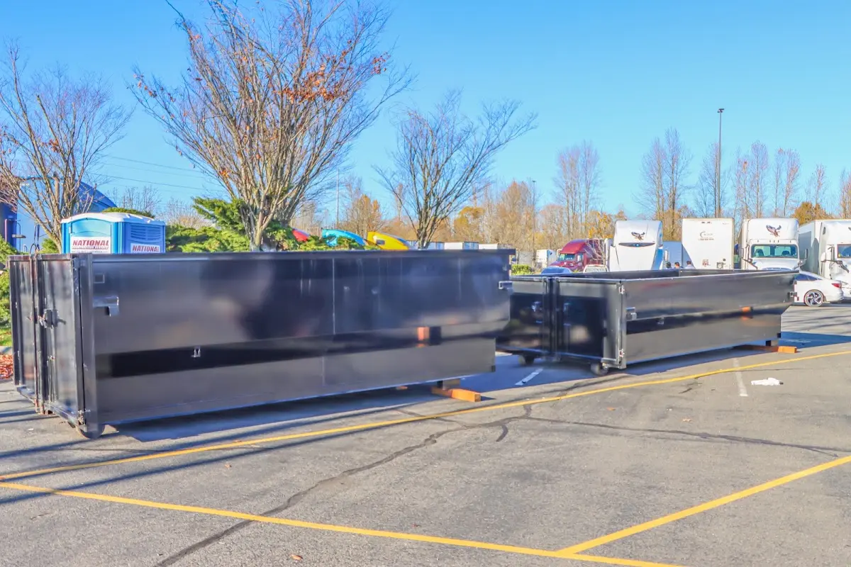 Professional dumpster rental service with roll-off container on residential driveway in Novato